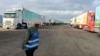 FILE PHOTO: Trucks carrying humanitarian aid from Egyptian NGOs for Palestinians, wait for the reopening of the Rafah crossing at the Egyptian side