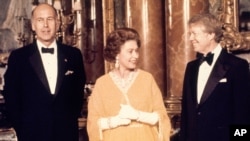 FILE - U.S. President Jimmy Carter, right, and Britain's Queen Elizabeth II are photographed with French President Valery Giscard d'Estaing, at Buckingham Palace in London in May 1977. 