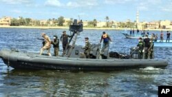 Egyptian coast guard and rescue workers bring ashore bodies recovered from a Europe-bound boat that capsized off Egypt's Mediterranean coast last week, in Rosetta, Egypt, Sept. 27, 2016.