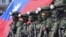 FILE - Soldiers pose for group photos with a Taiwanese flag after a preparedness enhancement drill simulating the defense against Beijing's military intrusions, ahead of the Lunar New Year in Kaohsiung City, Taiwan, on Jan. 11, 2023.