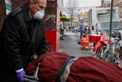 Funeral director Tom Cheeseman retrieves a body on a house call, April 3, 2020, in the Brooklyn borough of New York.