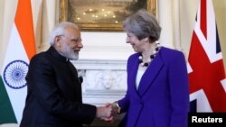 India's Prime Minister Narendra Modi shakes hands with Britain's Prime Minister Theresa May during a meeting at 10 Downing Street in London, Britain, April 18, 2018. 