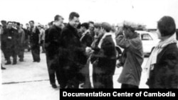 FILE - In this undated photo provided by Documentation Center of Cambodia, the late Khmer Rouge leader Pol Pot, center, greets Khmer Rouge cadre in Phnom Penh airport, Cambodia.