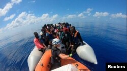 Migrants are seen on the Louise Michel ship operating in the Mediterranean Sea and financed by British street artist Banksy, Aug. 29, 2020. (MV Louise Michel/Handout via Reuters)