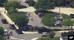 In this frame from video, people leave The Capital Gazette, a newspaper in Annapolis, Md., after multiple people had been shot, June 28, 2018.