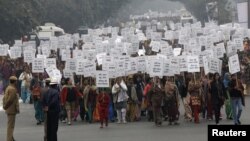 Women hold placards as they march during a rally organized by Delhi Chief Minister Sheila Dikshit (unseen) protesting for justice and security for women, in New Delhi, January 2, 2013.