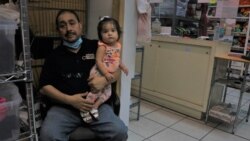 Jose Arevalo says the clothing print shop he manages has barely made ends meet since the border closure stopped the Mexican shoppers who used to patronize downtown Laredo. (Dylan Baddour/VOA)