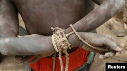 FILE - Nigeria says it has driven Boko Haram insurgents out of Adamawa state. Here, a suspected insurgent waits at a Chadian soldiers' field base in Gambaru, Nigeria, February 26, 2015. 