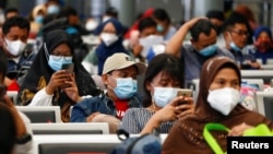 Penumpang menunggu di stasiun kereta untuk pulang ke kampung halaman menjelang perayaan Idul Fitri, di tengah pandemi COVID-19, di Jakarta, 5 Mei 2021. (REUTERS/Ajeng Dinar Ulfiana) 