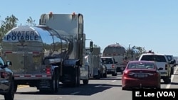 Residents, work crews and supply trucks make for congested traffic on Highway 231, the road to Panama City, Fla., in the wake of Hurricane Michael.