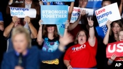 Supporters react as Democratic presidential candidate Hillary Clinton speaks during a rally at Theodore Roosevelt High School, Oct. 28, 2016, in Des Moines, Iowa.