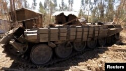 A tank destroyed recently during fighting between the Ethiopian National Defense Force (ENDF) and the Tigray People's Liberation Front (TPLF) forces is seen on the roadside in Gashena of Amhara region, Ethiopia Dec. 7, 2021.