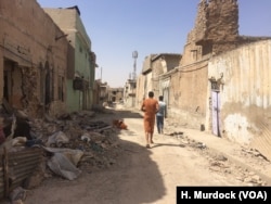 Families visit their homes in Mosul's Old City but say its too dangerous to move back home, Sept. 29, 2017.