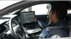 Arlington County Police Officer Patrice Malone checks the computer in her cruiser. (Mike Burke/VOA)