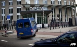 FILE - United Nations inspectors arrive in a van at the headquarters of the Organisation for the Prohibition of Chemical Weapons (OPCW), in The Hague, Aug. 31, 2013.