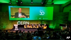 English computer scientist Tim Berners-Lee, 3rd left on the podium, best known as the inventor of the World Wide Web, attends an event at the CERN in Meyrin near Geneva, Switzerland, March 12, 2019. (Fabrice Coffrini/Pool, Keystone via AP)