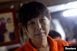 Than Dar, the wife of slain journalist Par Gyi, is seen during a Reuters interview at her home, in Yangon, Myanmar, Oct. 28, 2014.