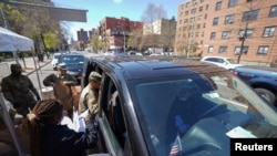 Members of the U.S. Army National Guard distribute boxes of free food provided by multiple New York City agencies, during the outbreak of the coronavirus disease in the Harlem neighborhood of Manhattan in New York City, April 15, 2020. 