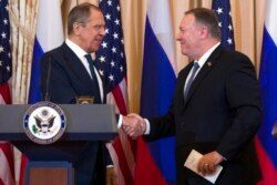 Secretary of State Mike Pompeo, right, shake hands with Russian Foreign Minister Sergey Lavrov, after a media availability at the State Department in Washington, Dec. 10, 2019.