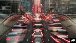 FILE - In this slow-shutter zoom effect photo taken Dec. 12, 2018, commuters backed up in traffic during the morning rush hour, in Brussels, a city that regularly experiences pollution alert warnings. 