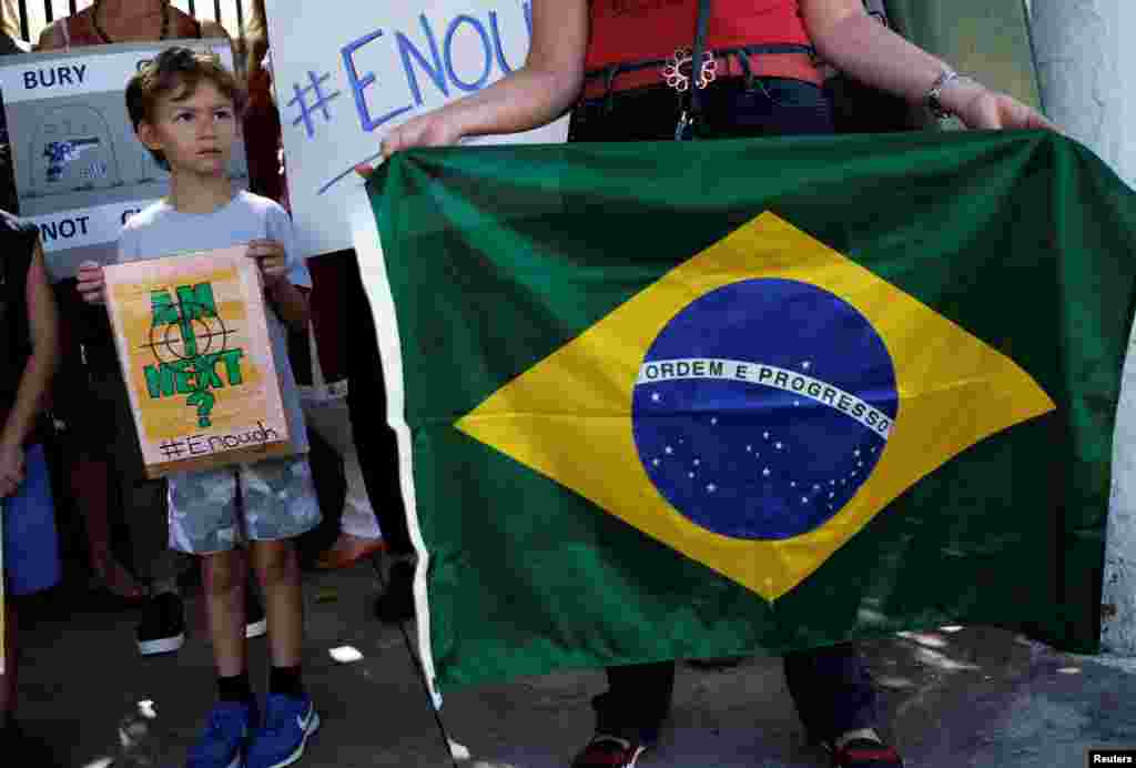 People take part in the "March for Our Lives" demonstration outside the U.S. Consulate in Sao Paulo, Brazil, March 24, 2018.