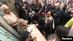 FILE - People gather outside an aid distribution center in the Red Sea port city of Hodeidah, Yemen, June 14, 2018. 