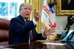 President Donald Trump speaks in the Oval Office, July 26, 2019, after announcing that Guatemala is signing an agreement to restrict asylum applications to the United States.