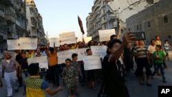 Activists in Syria’s besieged Aleppo protest against the United Nations for what they say is its failure to lift the siege off their rebel-held area, Sept. 13, 2016.