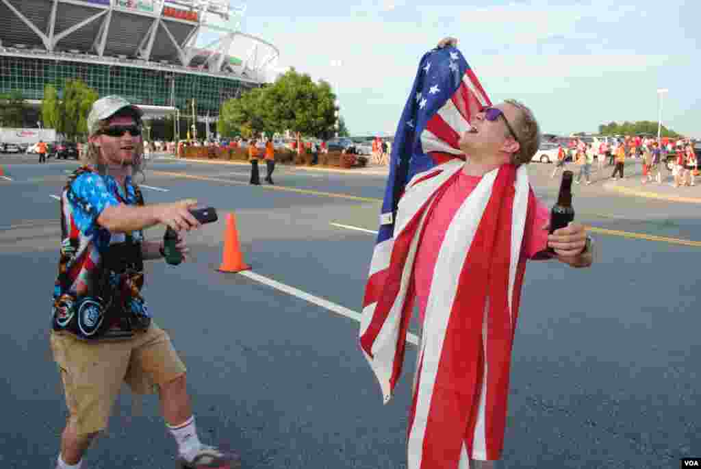 USA soccer supporters enjoy a lighter moment outside the stadium before the match. VOA/M. Lipin