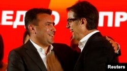 Macedonian Prime Minister Zoran Zaev and leader of the ruling SDSM greets presidential candidate Stevo Pendarovski during a news conference in Skopje, April 21, 2019. 