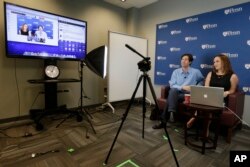 FILE -- University of Pennsylvania professor Peter Struck, accompanied by teaching assistant Cat Gillespie, teaches a mythology class during a live recording of a massive, open, online classes (MOOC), in Philadelphia.