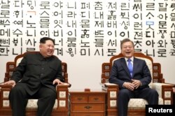 South Korean President Moon Jae-in talks with North Korean leader Kim Jong Un during their meeting at the Peace House at the truce village of Panmunjom inside the demilitarized zone separating the two Koreas, South Korea, April 27, 2018. Korea Summit Pr