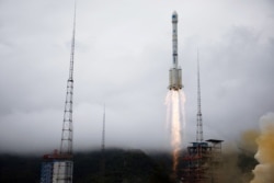 FILE - A Long March-3B rocket carrying the Beidou-3 satellite, the last satellite of China's Beidou Navigation Satellite System, takes off from Xichang Satellite Launch Center in Sichuan province, China, June 23, 2020.