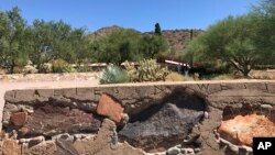 This Sept. 24, 2017 photo shows the words "Taliesin West" carved into a rock wall with the desert landscape visible in the background in Scottsdale, Ariz. The complex served as the winter home of architect Frank Lloyd Wright in Scottsdale, Arizona. (AP Photo/Anita Snow)