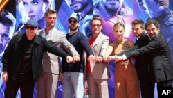 FILE - Marvel Studios President Kevin Feige, from left, poses with members of the cast of "Avengers: End Game," Chris Hemsworth, Chris Evans, Robert Downey Jr., Scarlett Johansson, Jeremy Renner and Mark Ruffalo at the TCL Chinese Theatre, April 23, 2019, in Los Angeles. (AP)