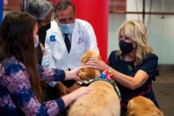 FILE - First lady Jill Biden visits with kids at a pediatric COVID-19 vaccine clinic in Texas Children's Hospital, in Houston, Nov. 14, 2021.