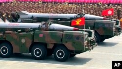 Military trucks carrying a missile parade the streets during a ceremony marking the 60th anniversary of the Korean War armistice in Pyongyang, North Korea, Saturday, July 27, 2013. (AP Photo/KRT via AP Video)
