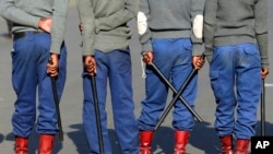 Zimbabwean riot police block a road ahead of a planned protest in Harare, Aug. 16, 2019.