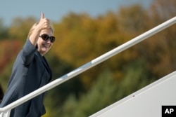 Democratic presidential candidate Hillary Clinton boards her campaign plane at Westchester County Airport in White Plains, N.Y., Oct. 18, 2016, to travel to Las Vegas for the third presidential debate.