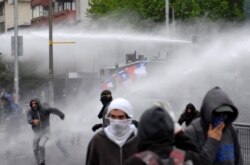 Demonstrators are sprayed by riot police water canons during a protest against Chile's government in Concepcion, Chile October 31, 2019. REUTERS/Jose Luis Saavedra