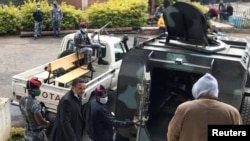FILE - Jawar Mohammed (L), an Oromo Activist and a media mogul, leaves the Lideta First Instance Court after appearing in court in Addis Ababa, Ethiopia, July 16, 2020. 