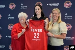 FILE - Indiana Fever's Caitlin Clark, middle, poses with general manager Lin Dunn, left, and head coach Christie Sides following a WNBA basketball news conference, Wednesday, April 17, 2024, in Indianapolis. (AP Photo/Darron Cummings)