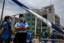 Police closed off the area outside the Next Media publishing offices as authorities conduct a search of the offices after the company's founder Jimmy Lai was arrested under the new national security law in Hong kong on August 10, 2020