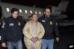 FILE - In this Jan. 19, 2017, file photo, provided by U.S. law enforcement, authorities escort Joaquin "El Chapo" Guzman, center, from a plane to a waiting caravan of SUVs at Long Island MacArthur Airport, in Ronkonkoma, N.Y.