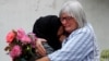 Women embrace near Masjid Al Noor mosque in Christchurch, New Zealand, March 17, 2019. 