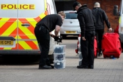 FILE - Inspectors from the Organization for the Prohibition of Chemical Weapons (OPCW) arrive to begin work at the scene of a nerve agent attack on former Russian agent Sergei Skripal, Salisbury, Britain, March 21, 2018.