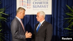 FILE - U.S. Vice President Mike Pence and Kosovo's President Hashim Thaci speak during a photo opportunity at the Adriatic Charter Summit in Podgorica, Montenegro, Aug. 2, 2017.