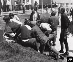 A Kent State University student lies on the ground after National Guardsman fired into a crowd of demonstrators on May 4, 1970 in Kent, Ohio. (AP Photo)