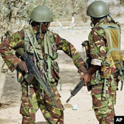 Kenyan soldiers talk as they prepare to advance near Liboi in Somalia on October 18, 2011