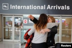 FILE - Mahnaz Kanani Zadeh, right, is greeted by her niece Negin after traveling to the U.S. from Iran following a federal court's temporary stay of U.S. President Donald Trump's executive order travel ban, at Logan Airport in Boston, Massachusetts, Feb. 6, 2017.